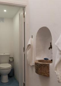 a bathroom with a toilet and a stone sink at Lavadeira's House in Olhão +21 photos