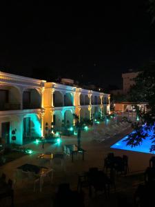 a large building with blue lights at night at Grand Vuslat Erdek in Erdek