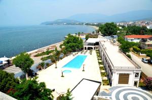 a view of a resort with a swimming pool and the ocean at Grand Vuslat Erdek in Erdek
