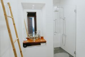 a bathroom with a glass bowl on a wooden table at Five Seven Nine Apartments in Porto