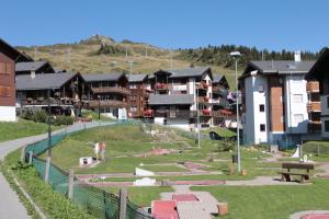 a group of buildings in a city with a park at Familienhotel Garni Sporting in Bettmeralp