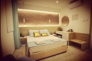 a bedroom with a bed with two towels on it at Hai Hotel in Larnaca