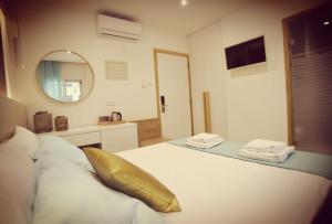a bedroom with a bed with a gold pillow on it at Hai Hotel in Larnaca