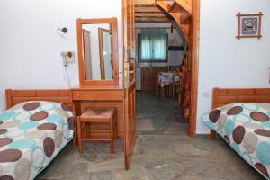 A bed or beds in a room at Panormos Maisonettes