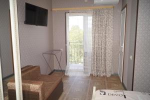 a living room with a sliding door with a window at Валентина in Gagra