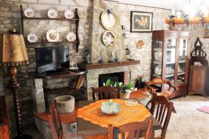 a dining room with a table and a fireplace at Il giardino del borgo in Rocca Cilento