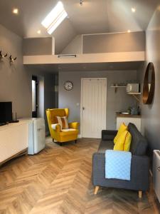 a living room with a couch and a chair at The Rhubarb Room in Barston