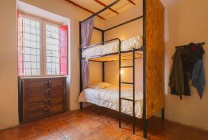 a bedroom with a bunk bed and a window at Botanico Hostel in Bogotá