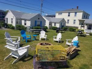 a group of chairs and a fire pit in a yard at Little Miss Cottages in Old Orchard Beach