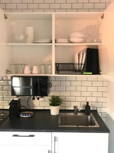 a kitchen with a sink and a microwave at Luxury Loft Malaga Torremolinos Sol in Torremolinos