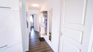 a hallway with a white door and wooden floors at Ferienwohnung "Meeresglück" in Rerik