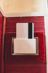 a white box on top of a red wall at Vertex Guest House in Rome