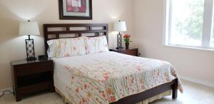 a bedroom with a bed with two night stands and two lamps at Ocean Paradise in Brinkleys
