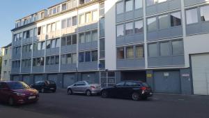 ケルンにあるSonniges Modernes Appartement Höhenbergの建物前に停車する車両群