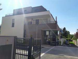 a white house with a balcony on top of it at Le Carré Confidentiel in Strasbourg