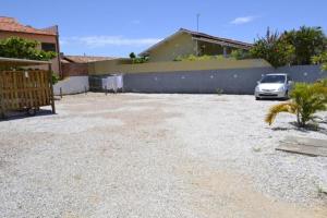 a car parked in a parking lot next to a building at Pousada Água da Fonte in Florianópolis
