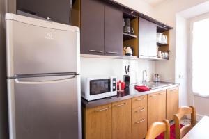 a kitchen with a stainless steel refrigerator and a microwave at Casa Laura Follonica in Follonica