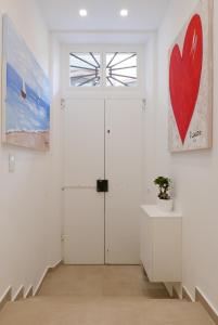 a room with a door and a red heart on the wall at S B&B (Pescara Centro) in Pescara
