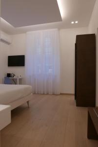 a living room with a bed and a television at S B&B (Pescara Centro) in Pescara