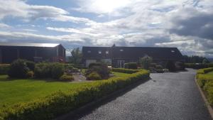 a barn and a house with a driveway at Antrim Heights Estate in Antrim