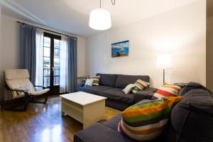 a living room with a couch and a table at Ubilla - Basquenjoy in Hondarribia