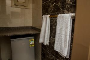 a bathroom with white towels hanging on a towel rack at El Mena Beach in Ras El Bar +19 photos