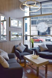 a living room with couches and a coffee table at Gran Mundo Hotel & Suites in Lima