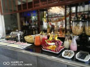 a buffet with fruit and other food on a counter at Hotel Spa Machupicchu in Tacna