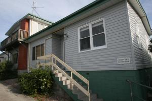 a gray house with a staircase on the side of it at Cedar Cottages Blackmans Bay in Kingston