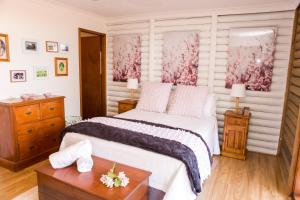 a bedroom with a bed and a wooden table at Among the Vines in Pokolbin