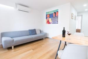 a living room with a couch and a table at Seaview Apartments Baska in Baška