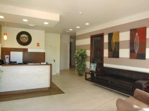 a lobby with a couch and a bar in a building at Hotel Las Canteras de Puerto Real in Puerto Real