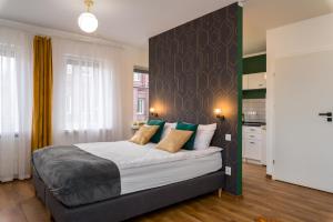 a bedroom with a large bed in a room at Sleepway Apartments- Green Dream in Poznań