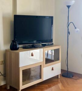 a flat screen tv on a wooden entertainment center at Apartment Lapov in Ičići