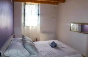 a bedroom with a bed with a hat on it at Accommodation Santor in Lastovo