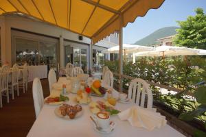 a table with plates of food on top at HOTEL LORENA in Toscolano Maderno