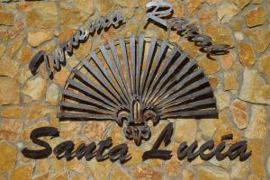 a sign for a santa autoria sign on a stone wall at Turismo Rural Santa Lucia in Ateca