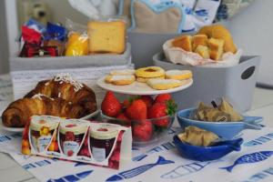 a table topped with plates of pastries and strawberries at 1919 in Sestri Levante +18 photos