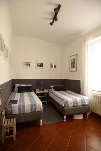 a bedroom with two beds and a ceiling fan at 1919 in Sestri Levante