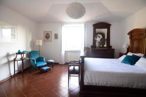a bedroom with a bed and a chair and a window at 1919 in Sestri Levante