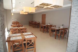 a row of tables and chairs in a restaurant at Hotel Paris Prestige in Izmir