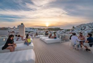 a group of people sitting on the roof of a building at Hotel California Urban Beach - Adults Only in Albufeira