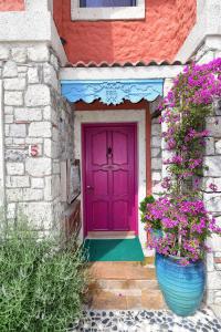 una porta viola su una casa con fiori di Alacati Suites ad Alaçatı