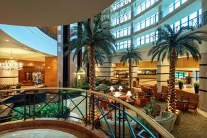 a lobby with palm trees in a building at InterContinental Almaty by IHG in Almaty