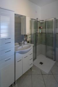 y baño con lavabo y ducha. en Appartamento Belvedere Sassos P 3267, en Tresnuraghes