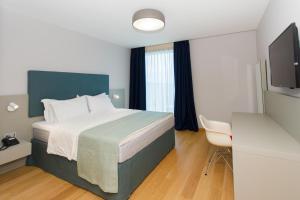 Postel nebo postele na pokoji v ubytování Buzë Boutique Hotel