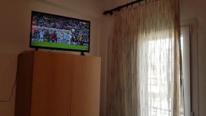 A television and/or entertainment centre at Efstathiou Mihail Studios and Apartments