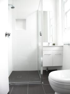 a bathroom with a shower and a toilet and a sink at Sunnyside Tavern in Newcastle