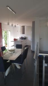 a kitchen with a glass table and chairs in it at Chambre chez particulier pour homme ou couple in Cannes