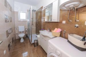a bathroom with a sink and a toilet at Apartment Petar in Kaštela +20 photos